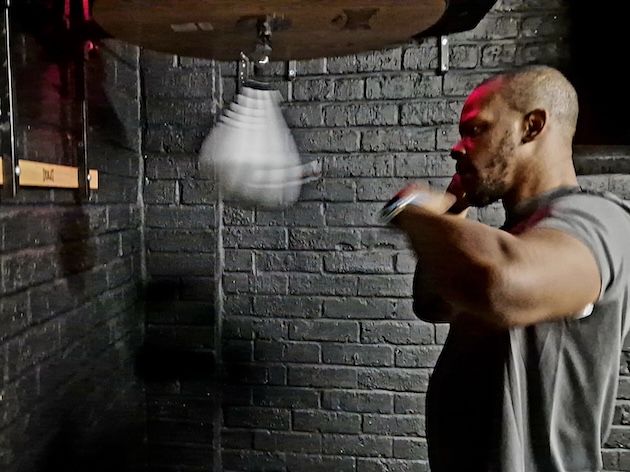 Boxer focused on speed bag training workout at Boxing Fitness MK gym