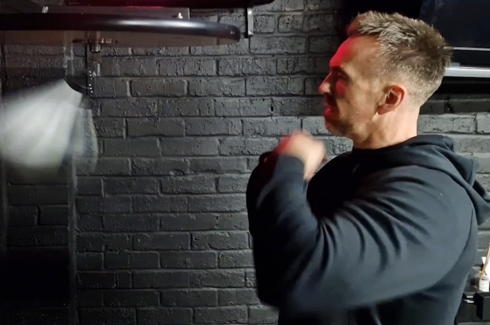 Man practicing speed bag boxing drills at Boxing Fitness MK gym in Milton Keynes