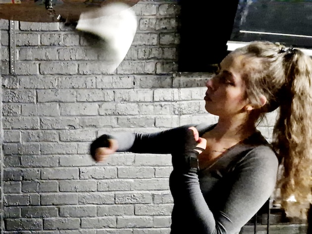 Woman enjoying speed bag workout training session at Boxing Fitness MK gym