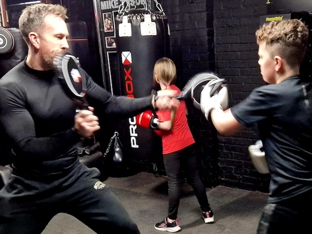 Children participating in family boxing class at Boxing Fitness MK gym in Milton Keynes