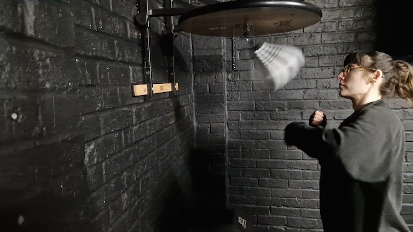 Female boxer practicing speed bag techniques during training session at Boxing Fitness MK