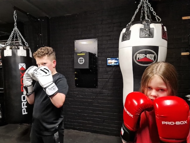Young junior boxers in fighting stance with Pro-Box gloves at Boxing Fitness MK gym